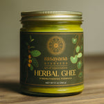 Jar of rasayana Ayurveda Herbal Ghee on a wooden surface with a neutral background