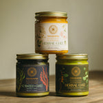 Three jars of herbal + seaweed ghee stacked on top of one another.
